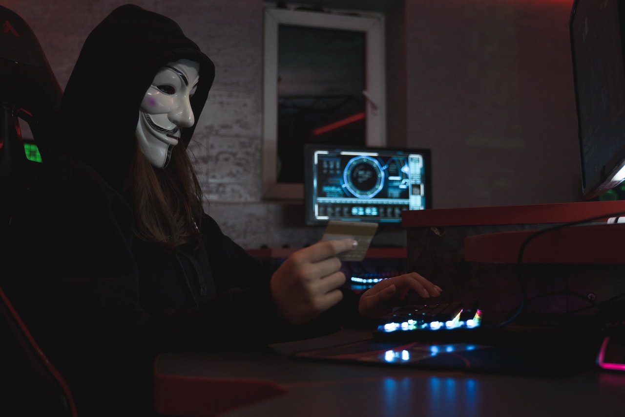 Hacker woman is wearing white mask on her face