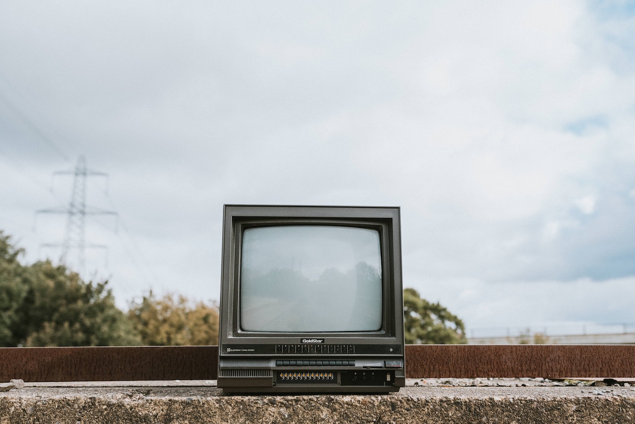 Old tv that is standing outside