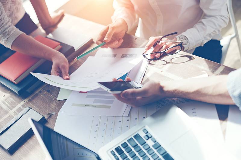 People are working hard and are choosing together the best stock photos
